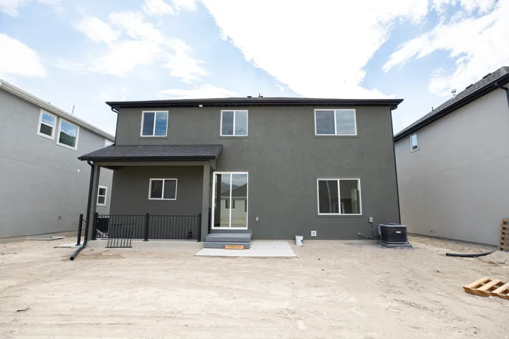Rear view of Redwood with exterior basement entrance for ADU in basement.