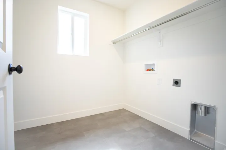 Full-size laundry room with natural light and washer/dryer hookups.