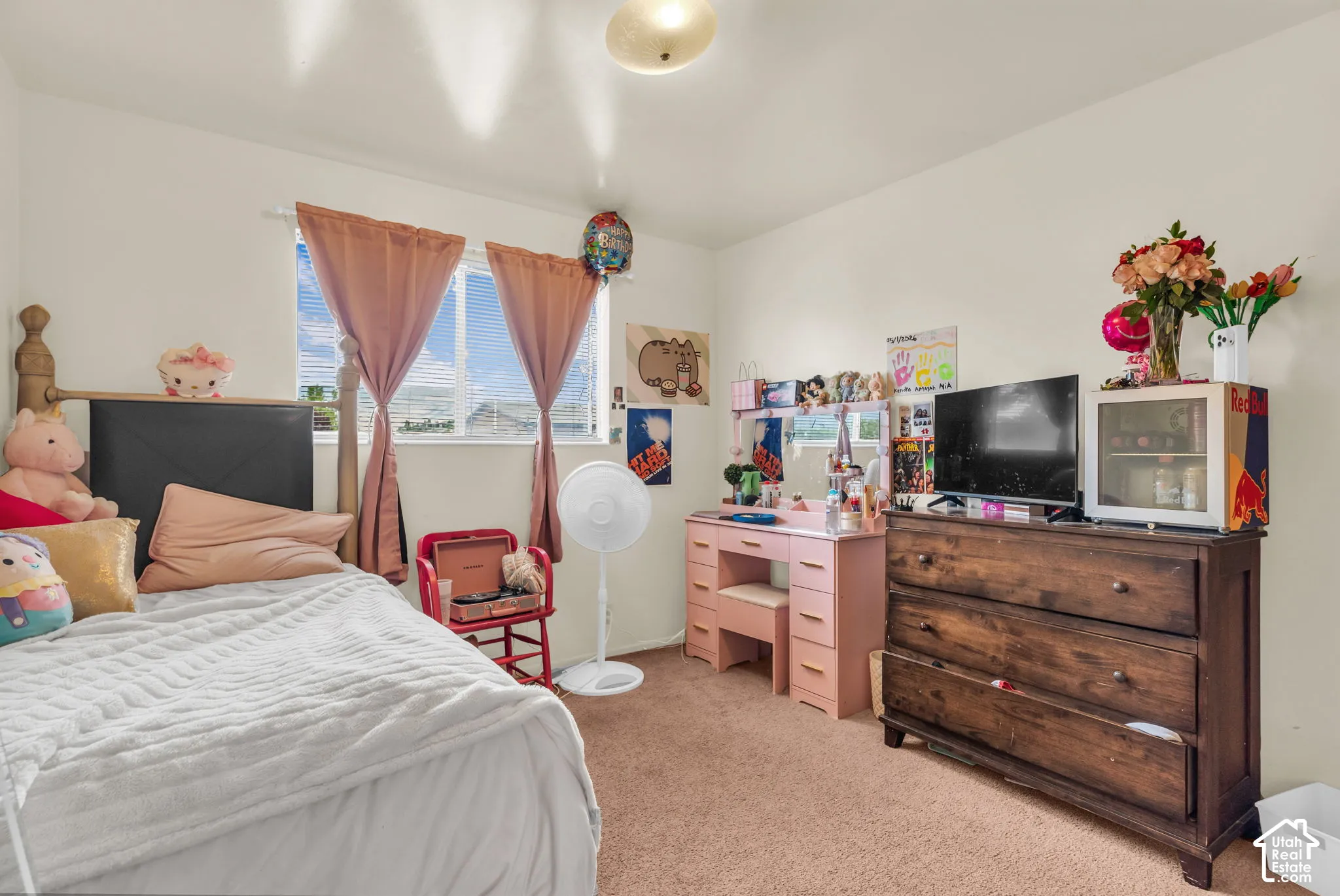 Carpeted room featuring a window with blinds, wood-finish bed frame, and built-in ceiling light fixture