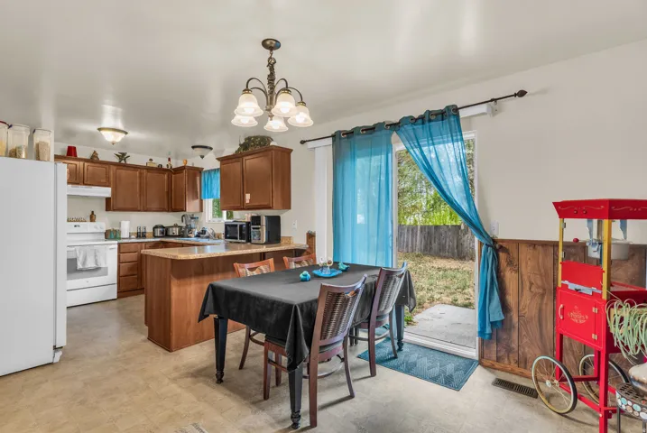 Kitchen and dining area featuring wood-finish cabinetry and light-colored countertops