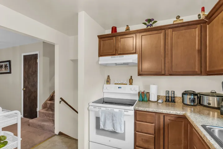 Kitchen area featuring wood-finish cabinetry and light-toned countertops