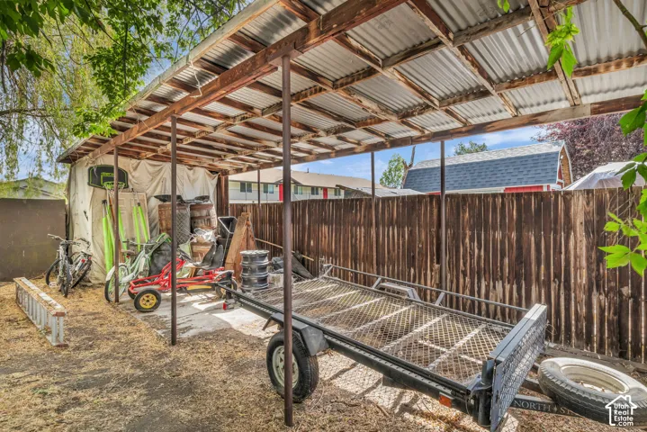 Expansive covered outdoor structure featuring a corrugated metal roof and exposed wood framing
