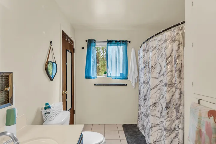 Bathroom with neutral wall color and square floor tiles