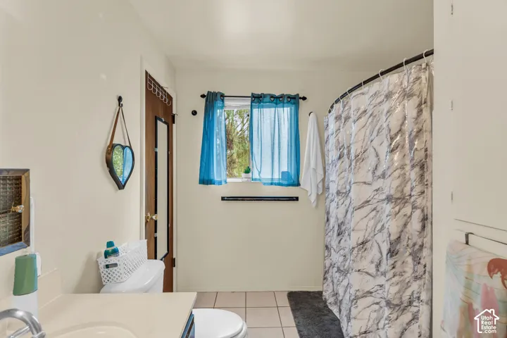 Bathroom with neutral wall color and square floor tiles