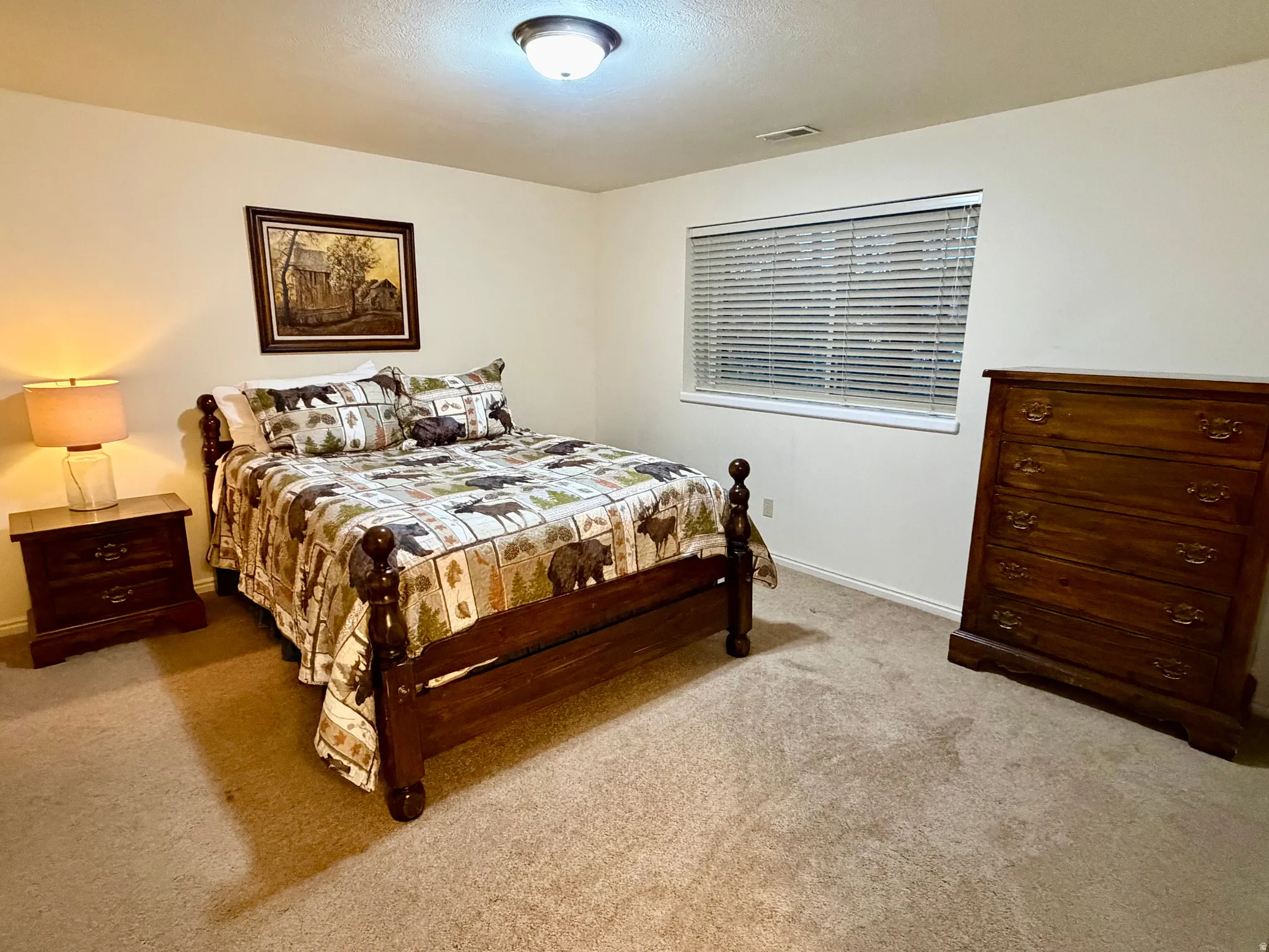 Carpeted room featuring light-toned walls, a window with blinds, and white trim molding