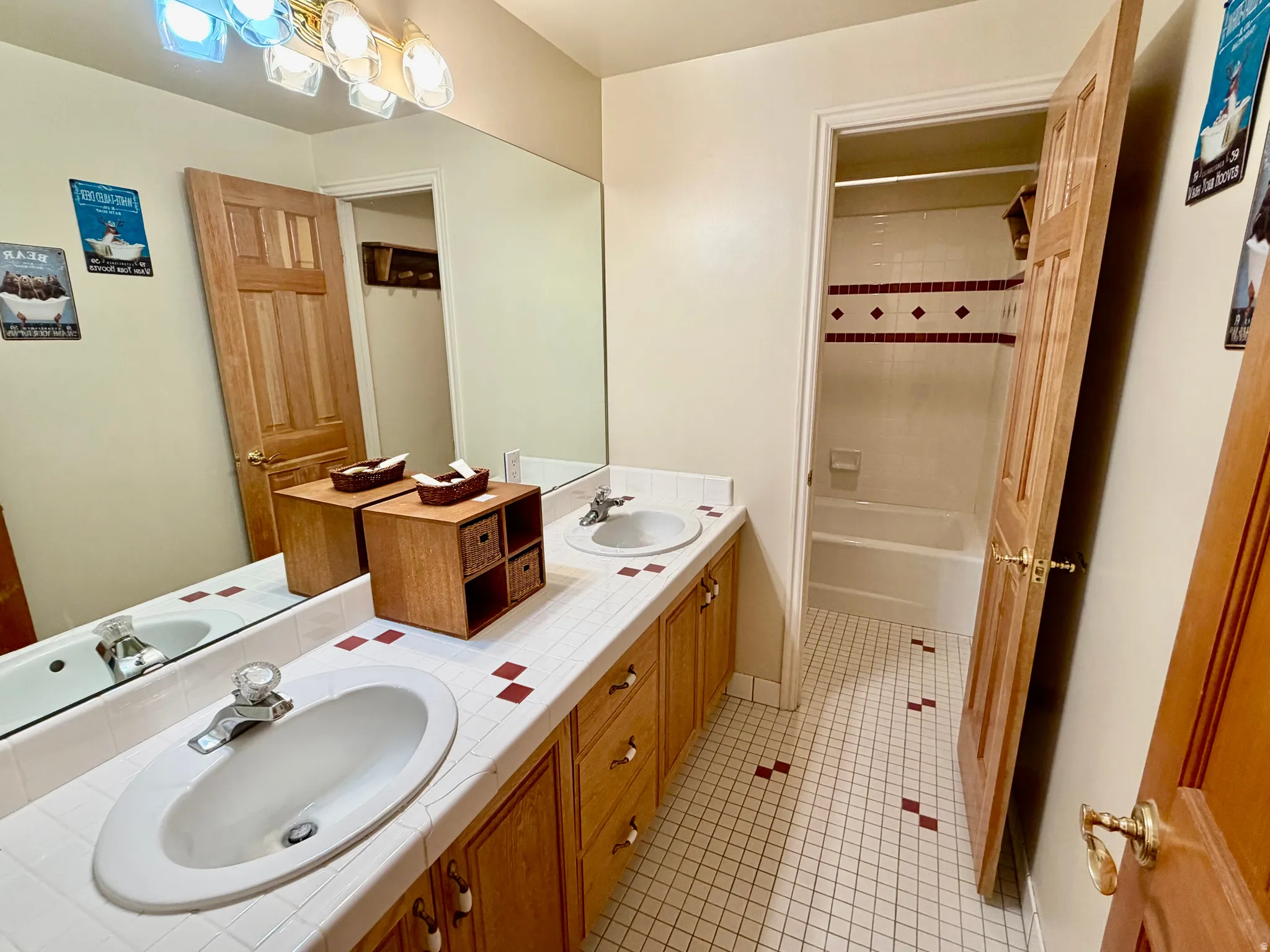 Double vanity featuring integrated sinks and tiled countertops