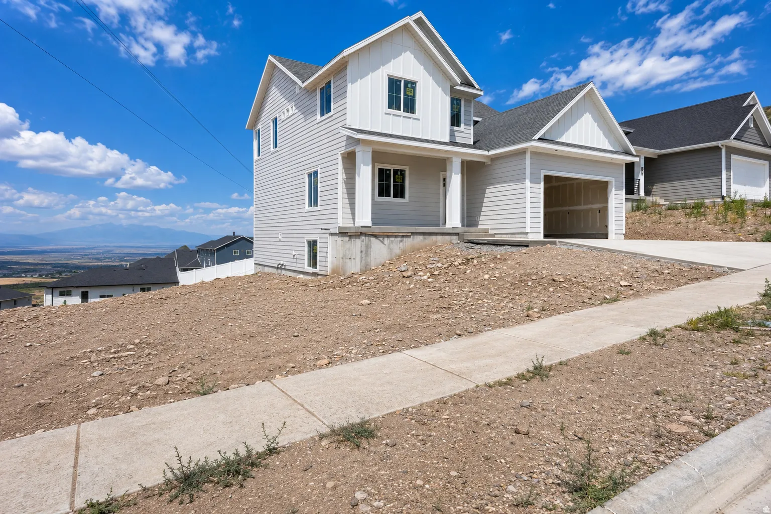 New construction residence featuring light gray siding and white trim