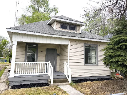 Light beige vinyl siding exterior with gray trim