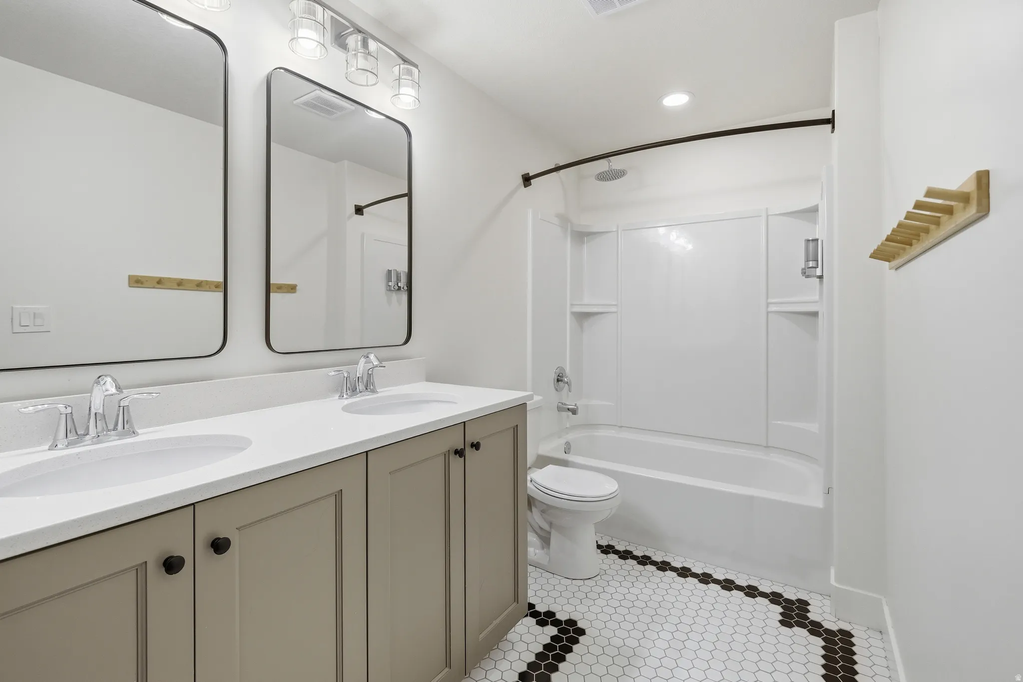 Double vanity with white countertop, chrome faucets, and rectangular undermount sinks