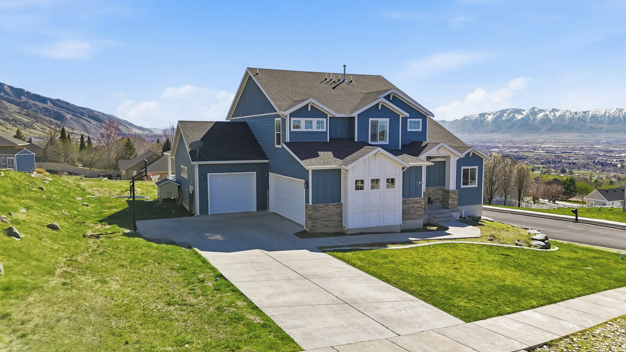 Contemporary two-story residence featuring blue siding and white trim