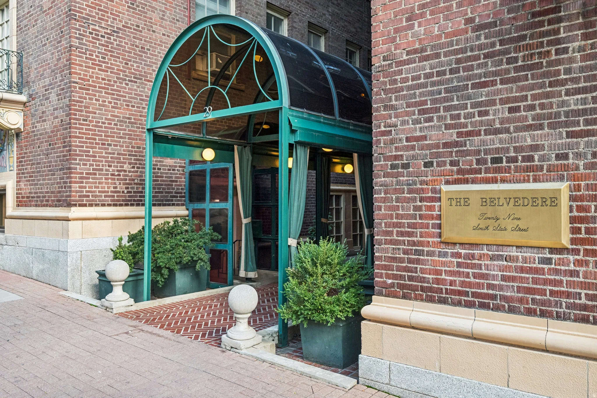 Brick facade building with a prominent arched entry awning