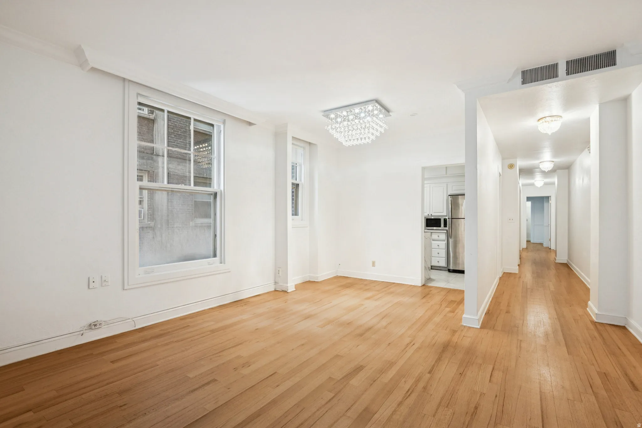 Spacious interior featuring hardwood flooring and white walls