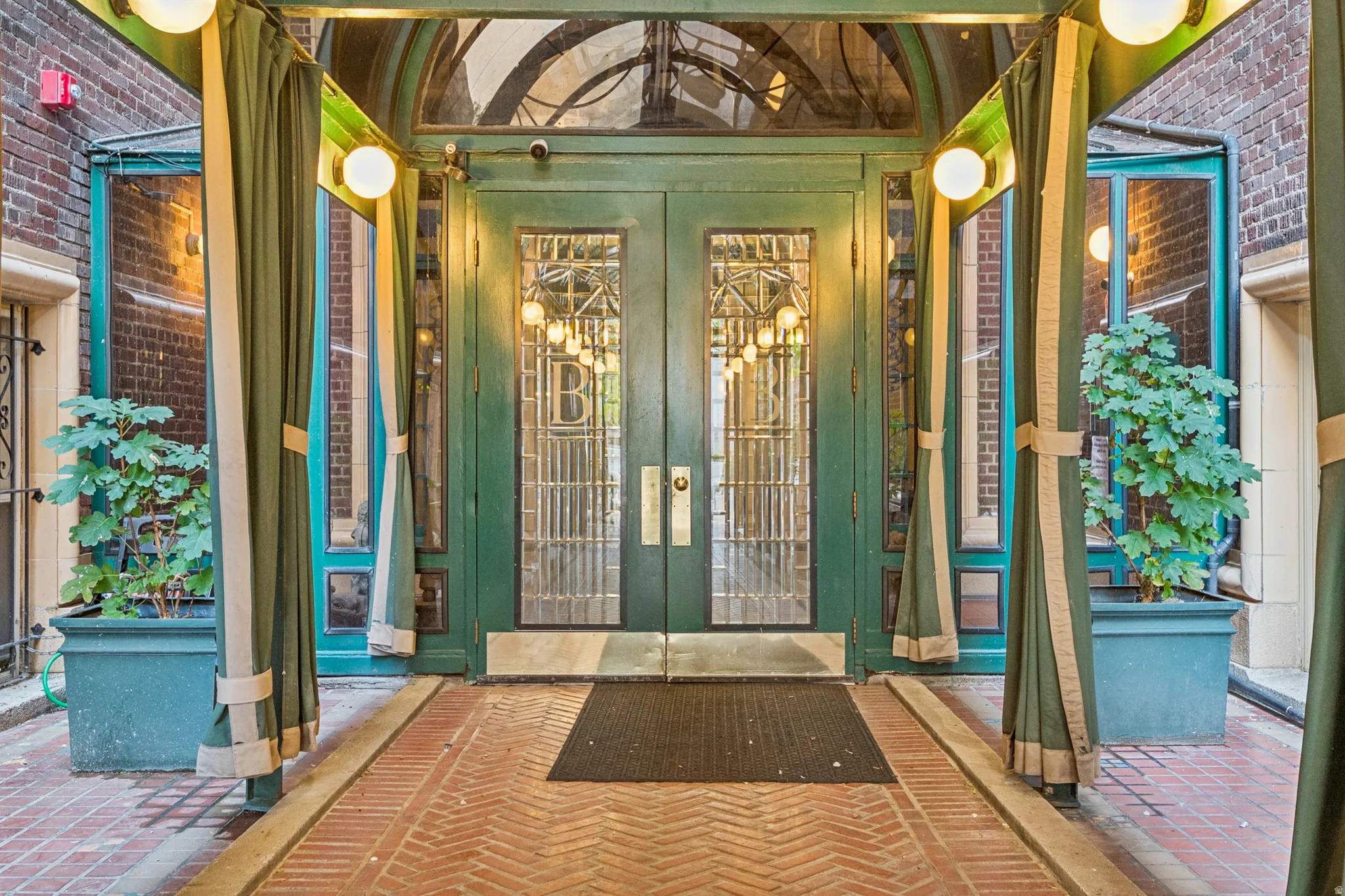 Double entry doors with decorative glass panels and brass hardware
