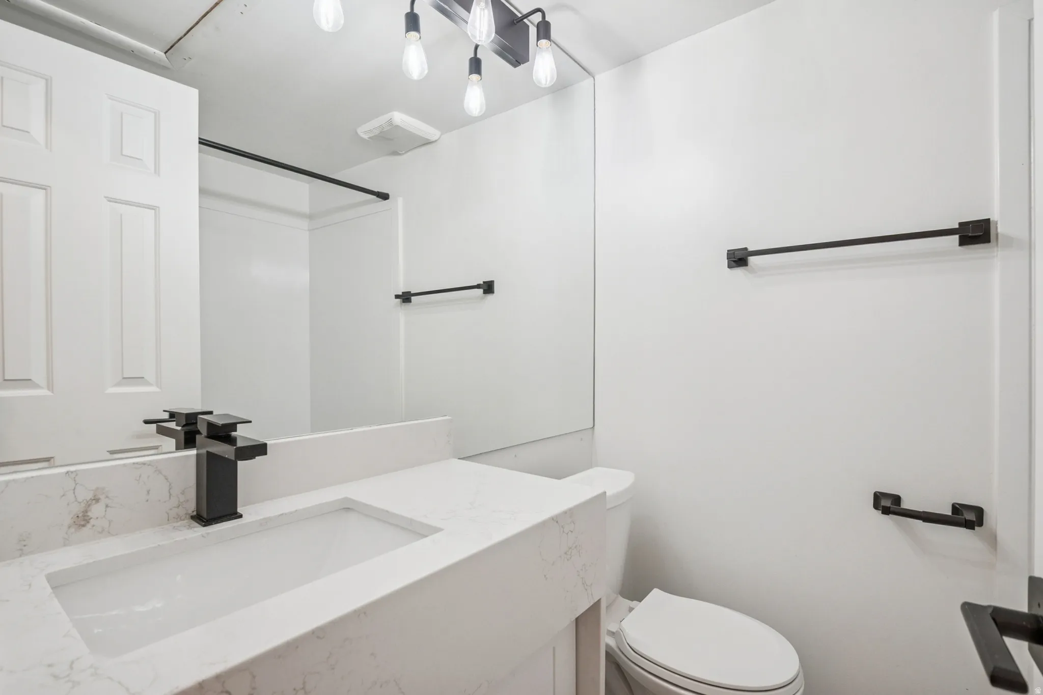 Bathroom 1 featuring a contemporary vanity with an integrated rectangular sink and a quartz-finish countertop
