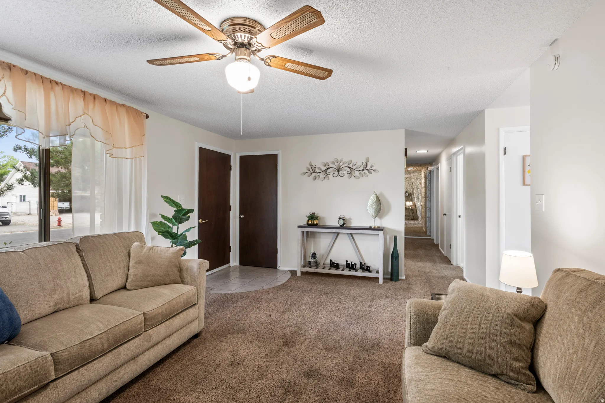 Expansive living space featuring neutral-toned walls and carpet flooring
