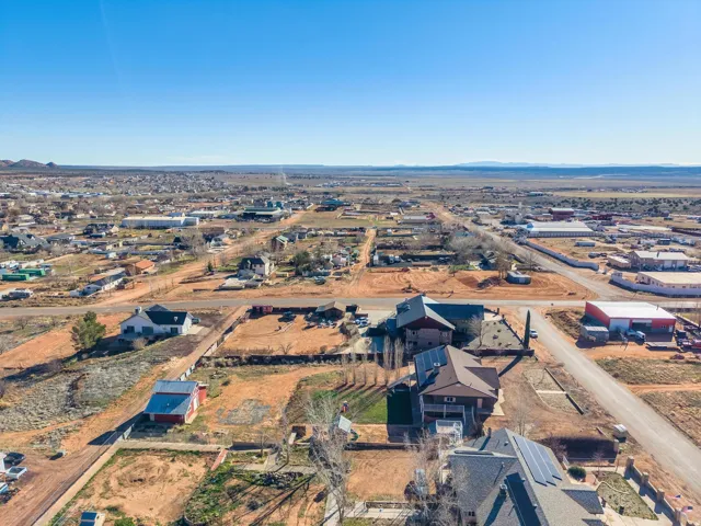 Expansive aerial perspective showcasing a residential and commercial area under a clear sky