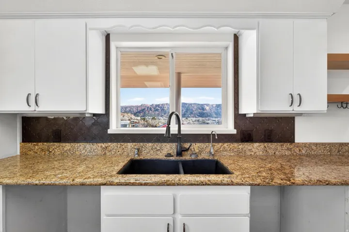Kitchen sink with a dual basin and matte black faucet, set against a window