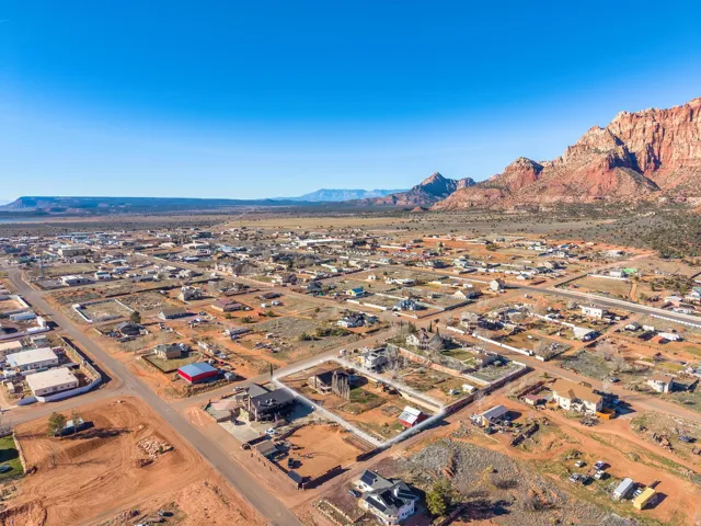 Expansive aerial presenting a residential area surrounded by natural rock formations