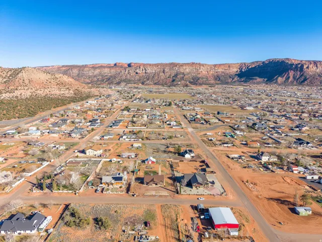 Aerial perspective showcasing a residential community set against a backdrop of natural rock formations