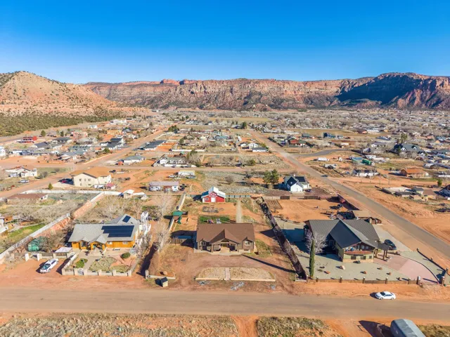 Expansive desert landscape featuring residential development with mountain backdrop