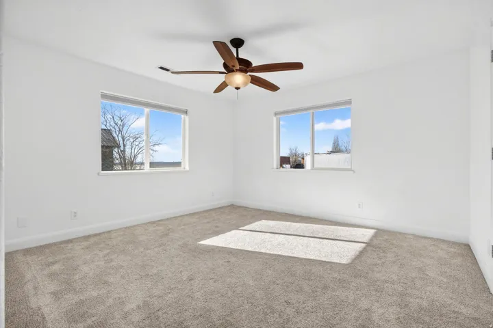Neutral color palette featuring light gray carpeting and white walls