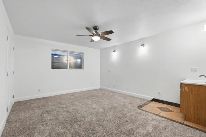 Spacious room featuring neutral carpeting and white walls