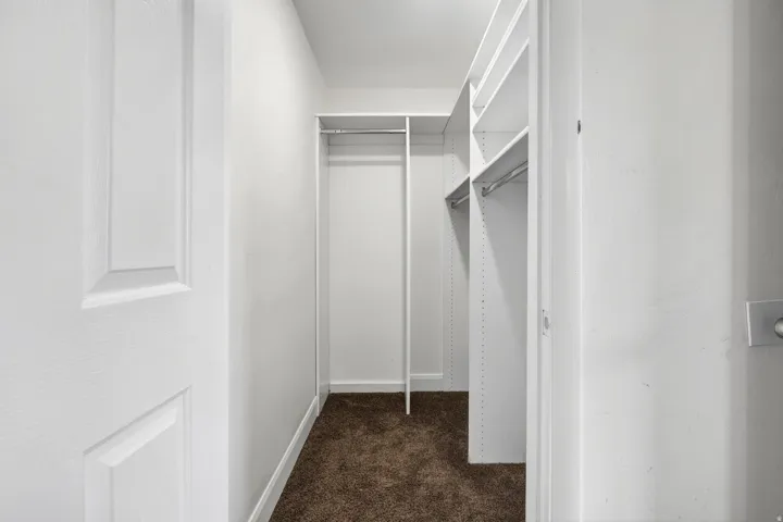 Integrated closet system featuring multiple shelving units and hanging rods