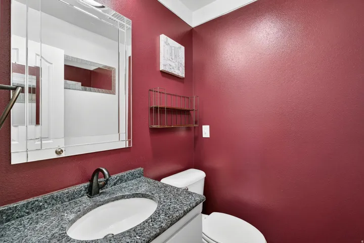 Vanity featuring a dark stone countertop, undermount sink, and oil-rubbed bronze faucet