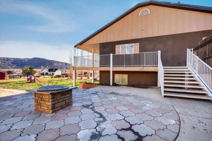 Paved patio featuring a stone-clad fire pit