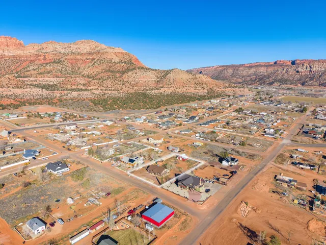 Expansive aerial view showcasing a residential area set against a mountain backdrop