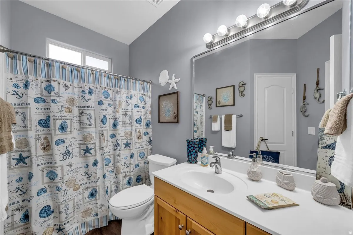 Bathroom featuring a single vanity with wood-finish cabinetry and a white countertop