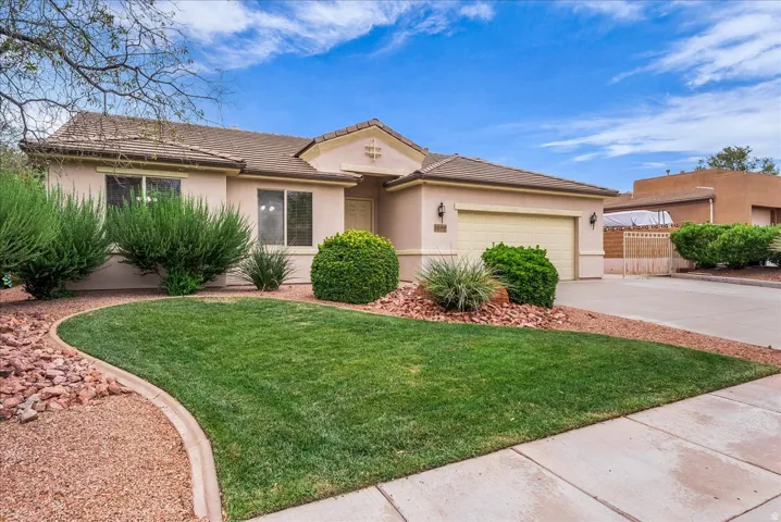Single-story residence featuring a stucco exterior, an attached two-car garage, and a concrete driveway