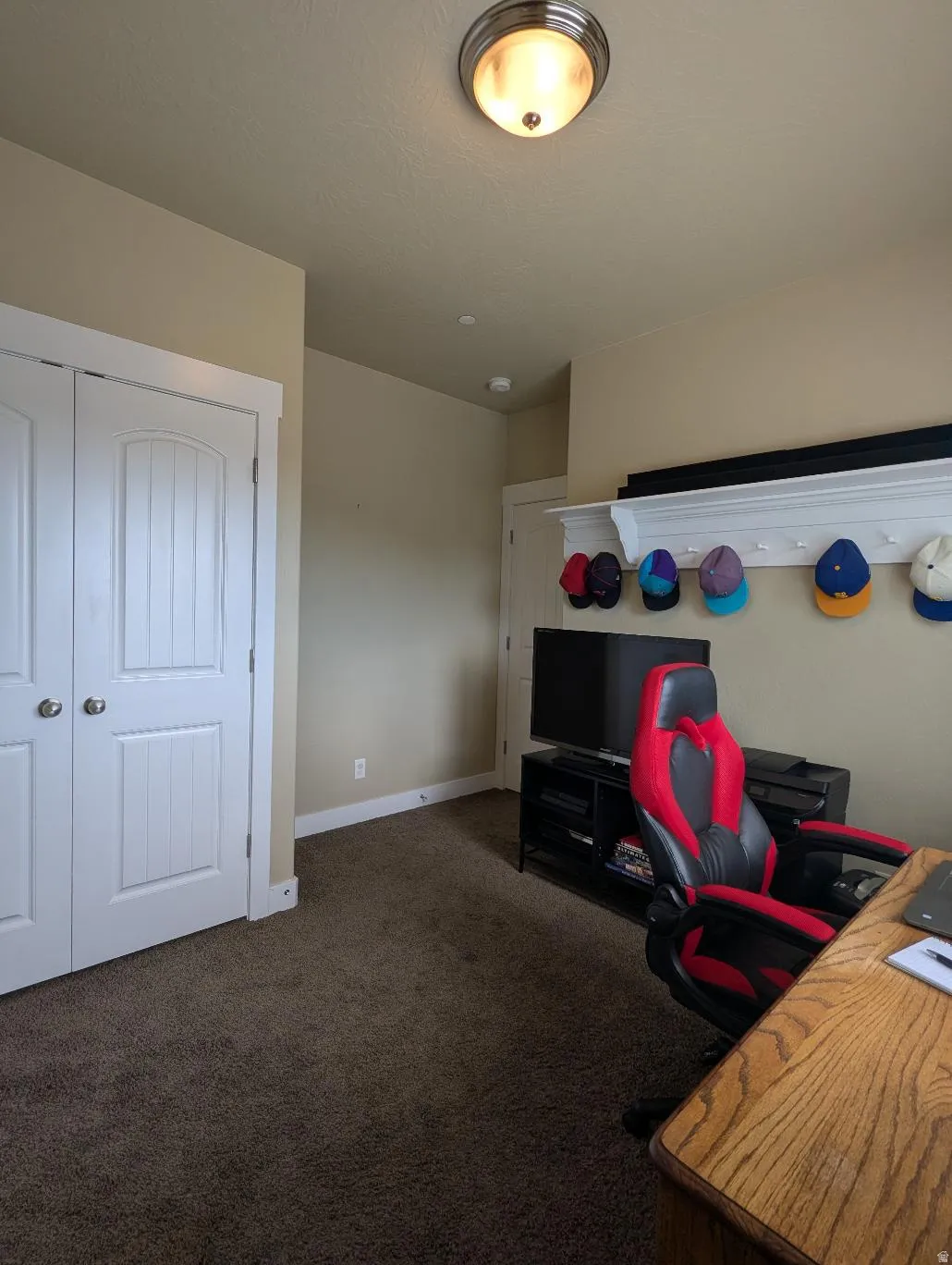 Room featuring neutral wall tones and dark carpeting