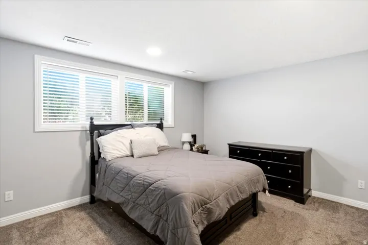 Room featuring light gray painted walls, recessed ceiling lighting, and carpet flooring