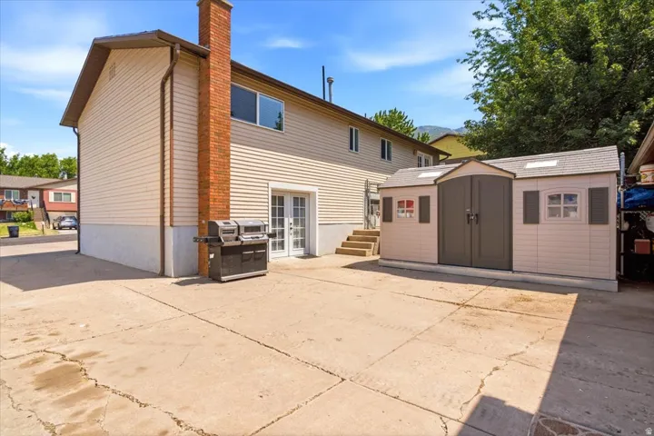 Expansive concrete patio with direct access to the home via double French doors