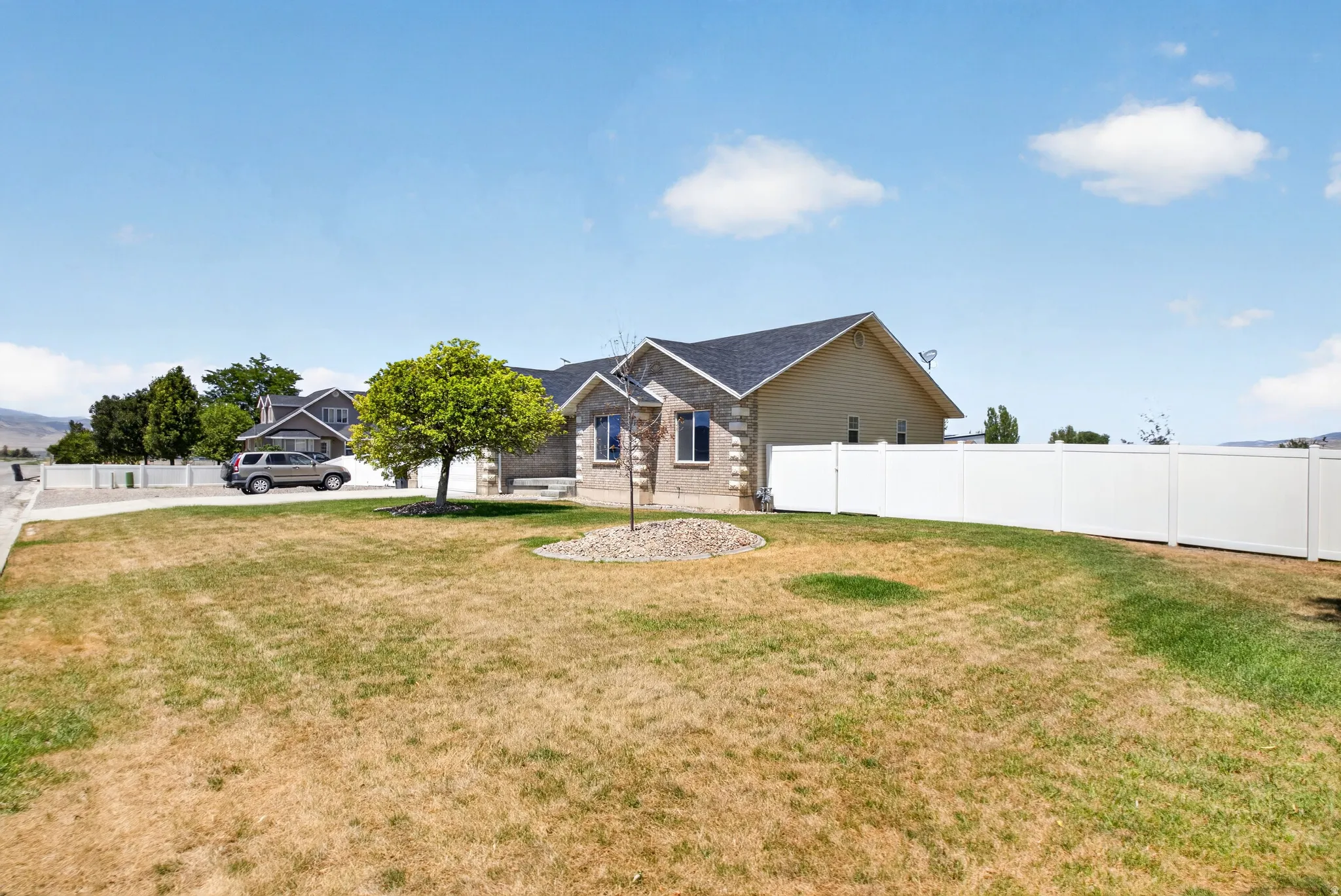Single-story home featuring a partial stone facade, attached garage, and a asphalt shingle roof