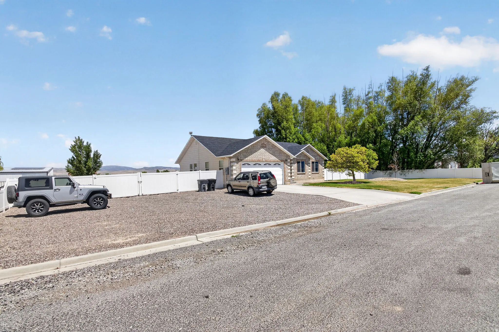 Ranch-style exterior with a brick facade accent and a two-car garage