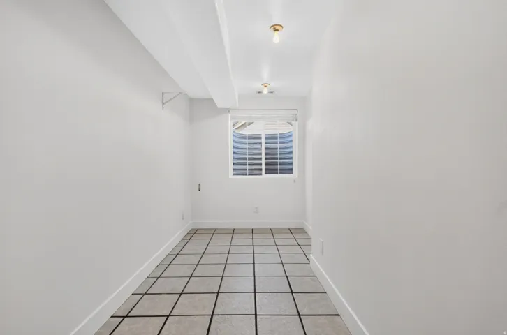 Recessed window offering natural light, complemented by a window well