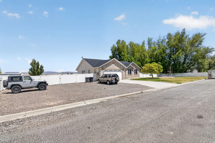 Ranch-style exterior with a brick facade accent and a two-car garage