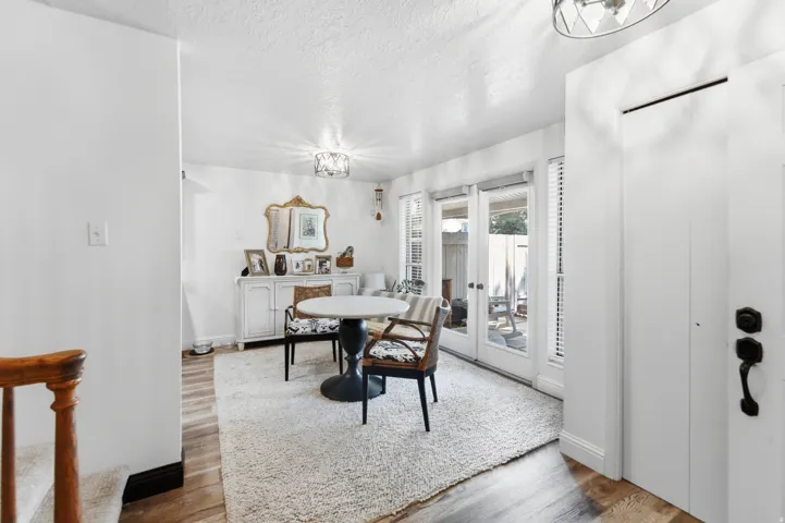 Interior space featuring wood-finish flooring, a plush area rug, and white walls