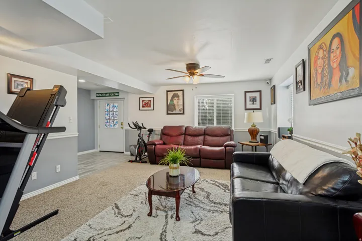 Recessed lighting, ceiling fan, carpeted flooring, window with blinds, and a paneled door