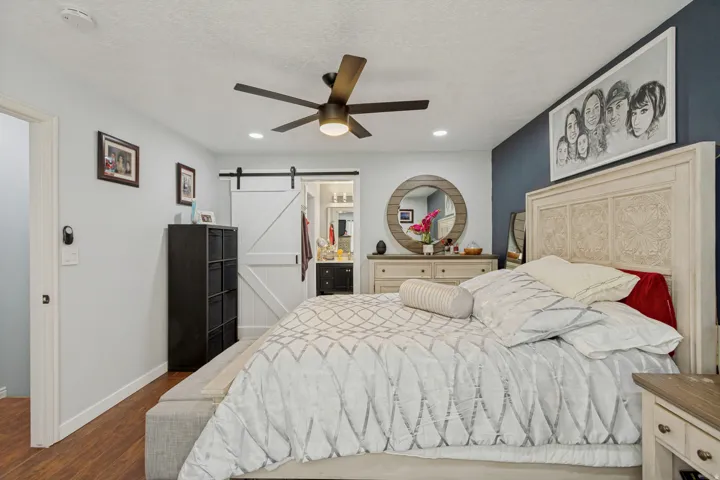 Recessed lighting, wood-finish flooring, ceiling fan, and a barn door