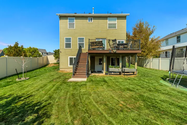 Expansive green lawn with a vinyl privacy fence