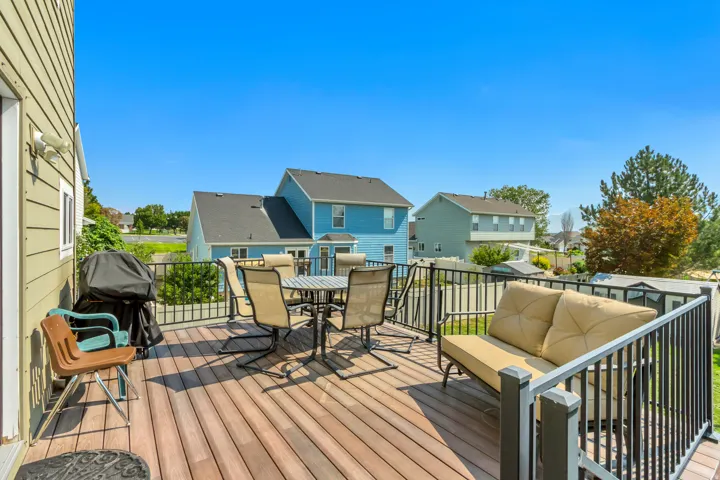 Expansive outdoor deck featuring wood-finish flooring and black metal railings