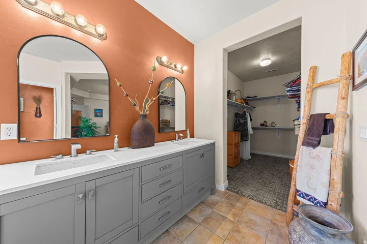 Dual vanity with rectangular undermount sinks and modern faucets, set against an accent wall