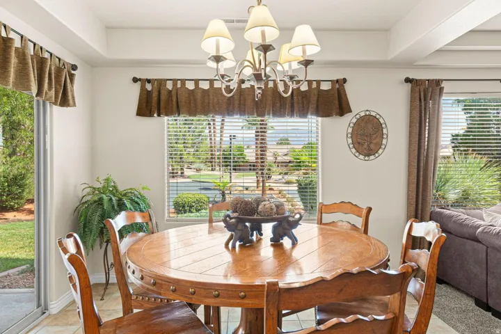 Dining area with tray ceiling and chandelier lighting