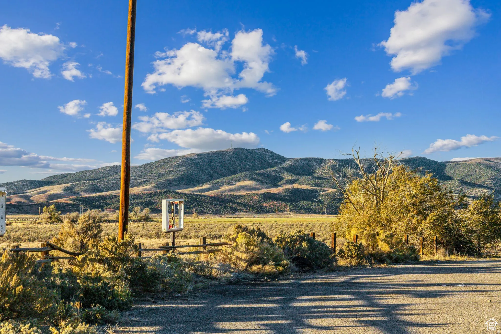 Expansive open terrain featuring natural vegetation and distant mountains