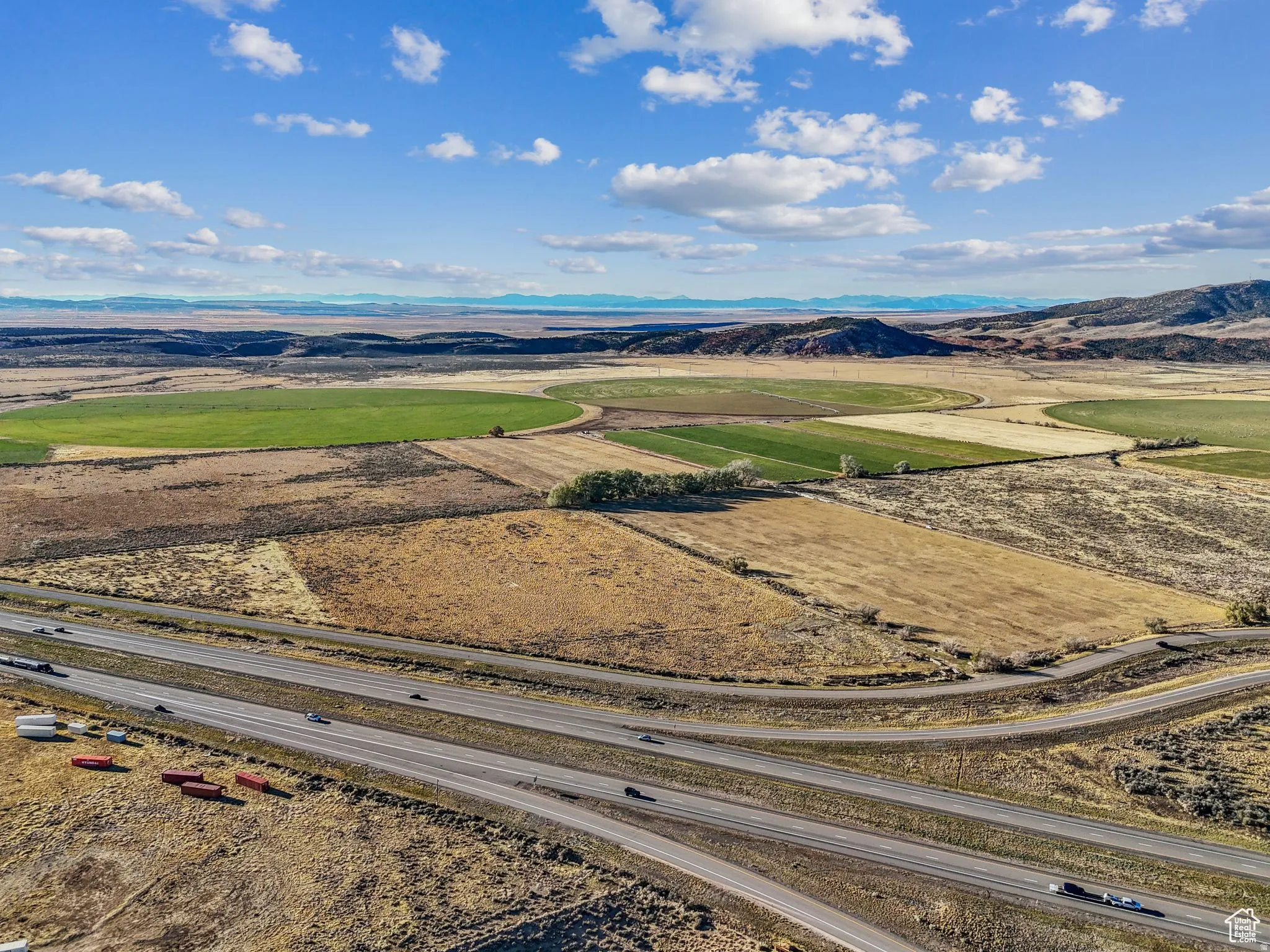 Expansive agricultural landscape featuring varied terrain and cultivated fields