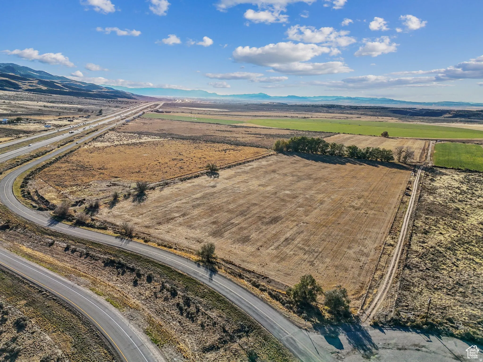 Expansive land parcel featuring open fields and distant mountain ranges