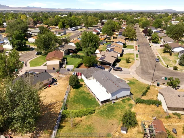 Aerial perspective showcasing a residential neighborhood with a distant mountain range backdrop